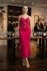 Woman in a pink dress standing in an urban setting