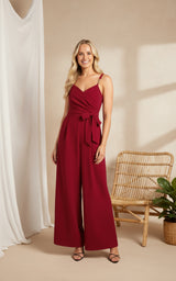 Woman wearing a red jumpsuit on a white background