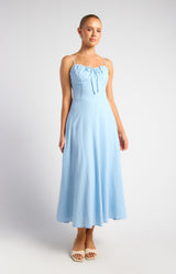 Woman wearing a light blue dress on a white background